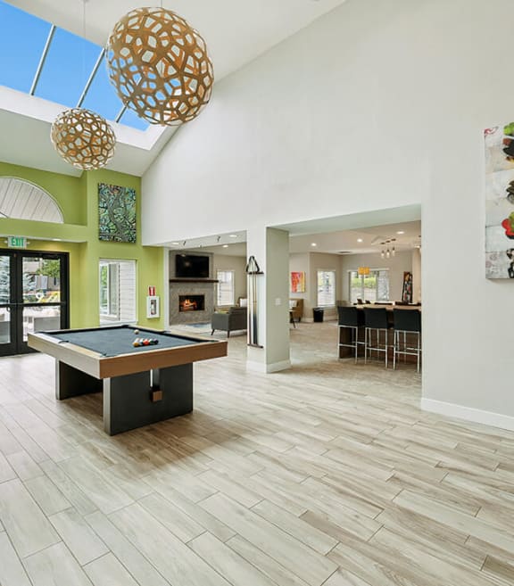 Community Clubhouse with Game Tables and Lounge Furniture at The Club Apartments located in Hillsboro, OR-SMLAM.