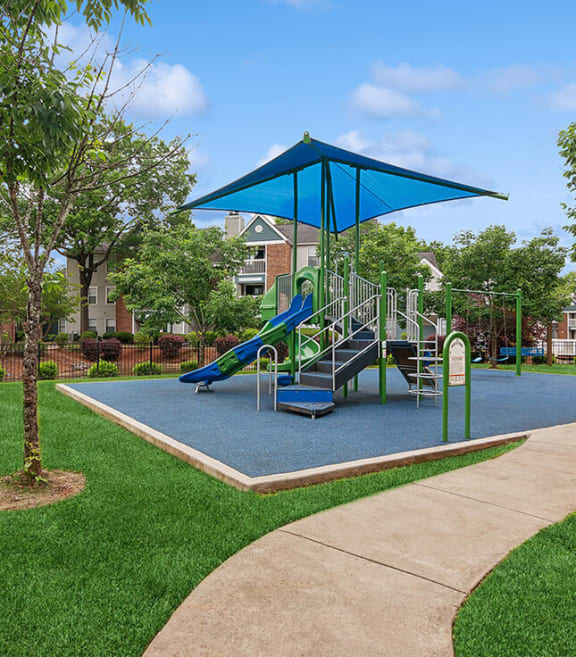 Community Playground with a Slide, Blue Canopy and Swing Set at Park 2300 Apartments in Charlotte, NC-SMLAM.