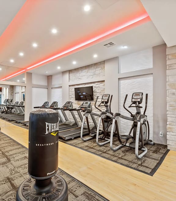 Community Fitness Center with Equipment at Essence Apartments in Dallas, TX.