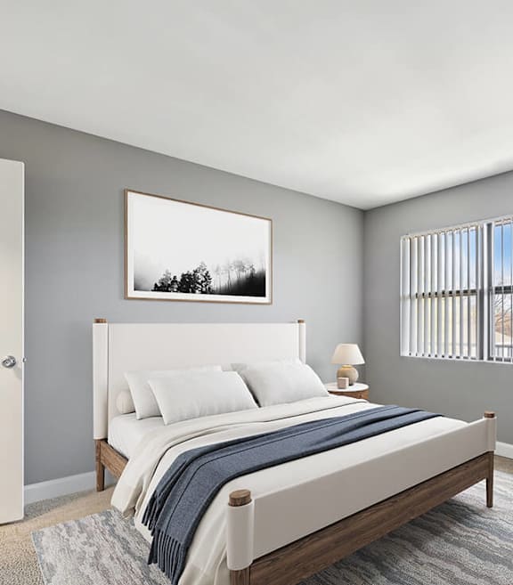 Model Bedroom with Carpet and Window View at Fox Valley Villages Apartments located in Aurora, IL-SMLAM.