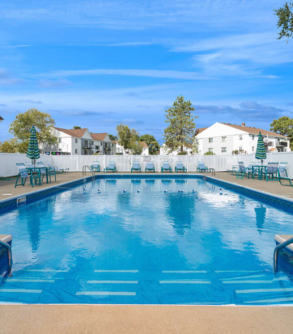 Community Swimming Pool with Pool Furniture at Village at Marshfield Apartments located in Marshfield, MA-SMLAM.