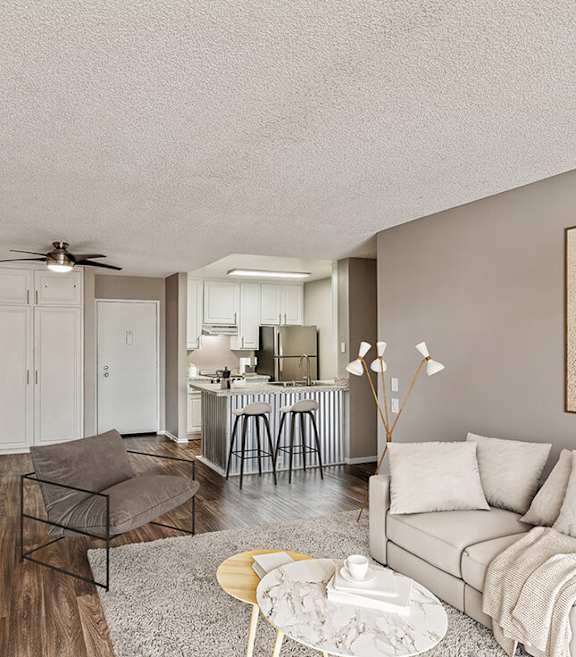 Model Living Room and Kitchen with Wood-Style Flooring at Crystal View Apartments located in Garden Grove, CA.