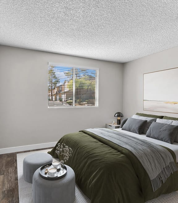 Model Bedroom with Carpet and Window View at Meadow Ridge Apartments located in Las Vegas, NV-SMLAM.