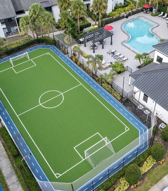 Aerial View of Soccer Field & Swimming Pool at Rosehill Preserve Apartments located in Orlando, FL-SMLAM.