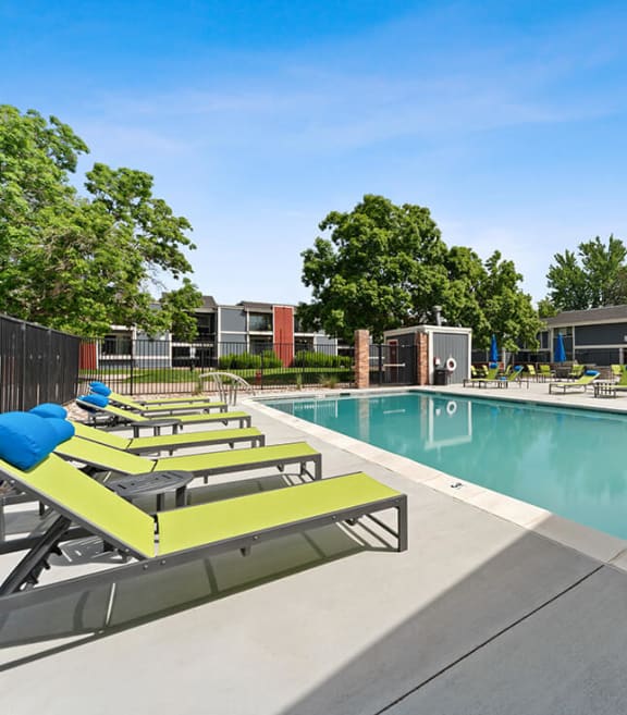 Community Swimming Pool with Pool Furniture at Bridges at 9 Mile Station Apartments in Denver, CO-SMLAM.