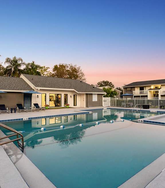 Community Swimming Pool with Pool Furniture at Arbors at Orange Park Apartments located in Orange Park, FL-SMLAM.