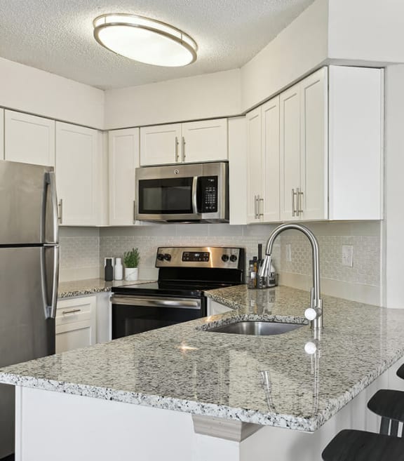 Model Kitchen with White Cabinets at Retreat at Crosstown Apartments in Riverview, FL-SMLAM