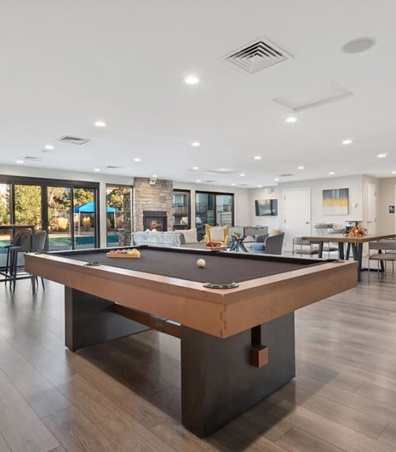 Community Clubhouse with Lounge Furniture and Pool Table Area at Liberty Creek Apartments in Aurora, CO-SMLAM.