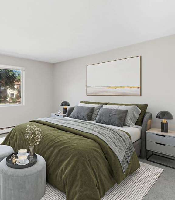 Model Bedroom with Carpet and Window View at Village at Marshfield Apartments located in Marshfield, MA-SMLAM.