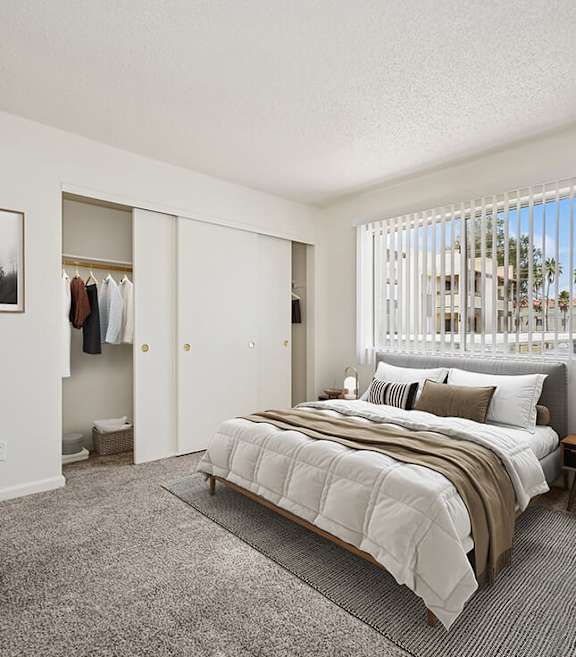 Model Bedroom with Carpet and Large Closet at Butler Ridge Apartments located in Glendale, AZ-SMLAM.