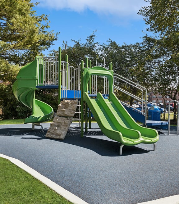 Community Playground with Two Slides at Middlesex Crossing Apartments located in Billerica, MA-SMLAM.