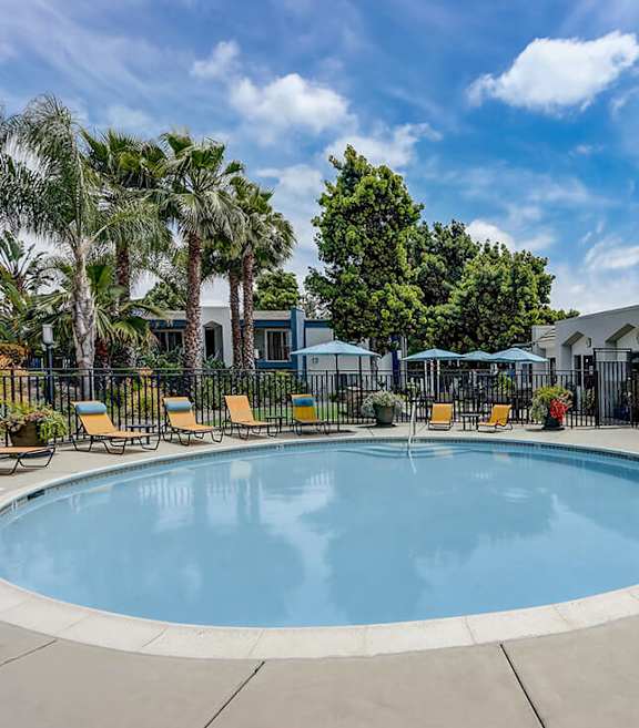 Community Swimming Pool with Pool Furniture at Cove La Mesa Apartments located in La Mesa, CA-SMLAM.