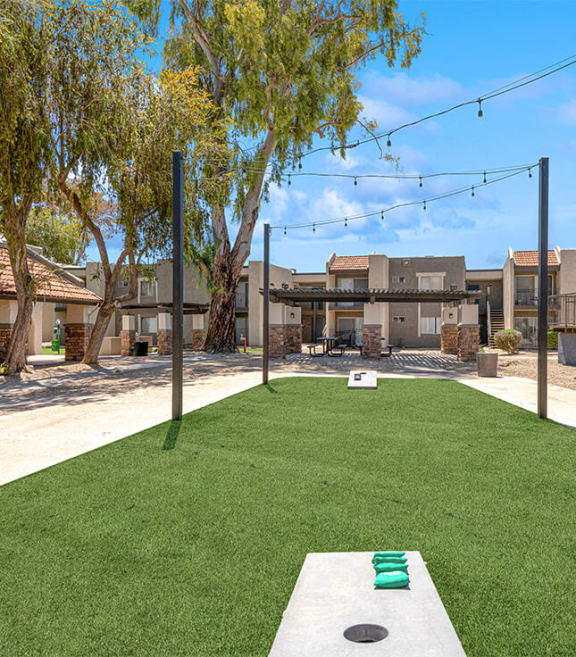 Outdoor Corn Hole Area at Village at Metro Center Apartments located in Phoenix, AZ-SMLAM.