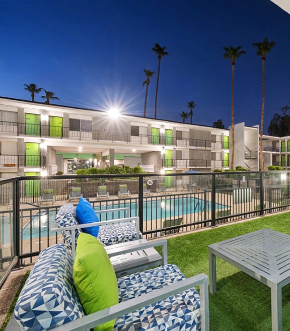 Outdoor Patio with Lounge Furniture and View of Pool at Arcadia on 49th Apartments located in Phoenix, AZ-SMLAM.