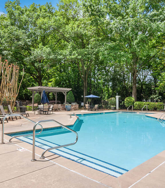 Community Swimming Pool with Pool Furniture at Arbor Village Apartments in Charlotte, NC-SMLAM.