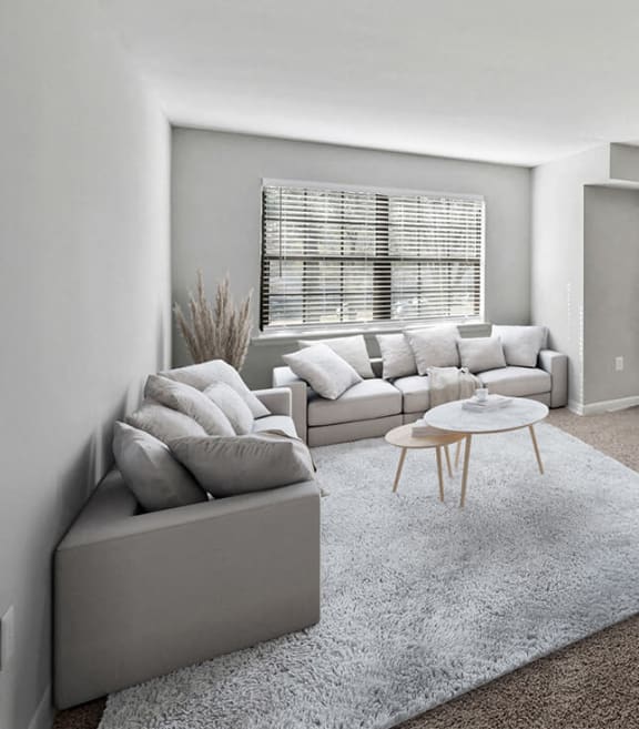 Model living room with large window at Dale Forest Apartments in Dale City, Virginia