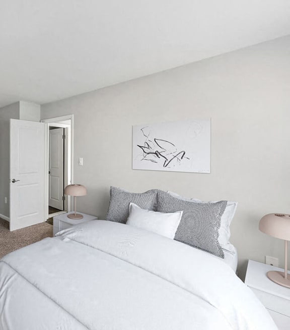 Model bedroom with canvas hanging behind the bed at Dale Forest Apartments in Dale City, Virginia