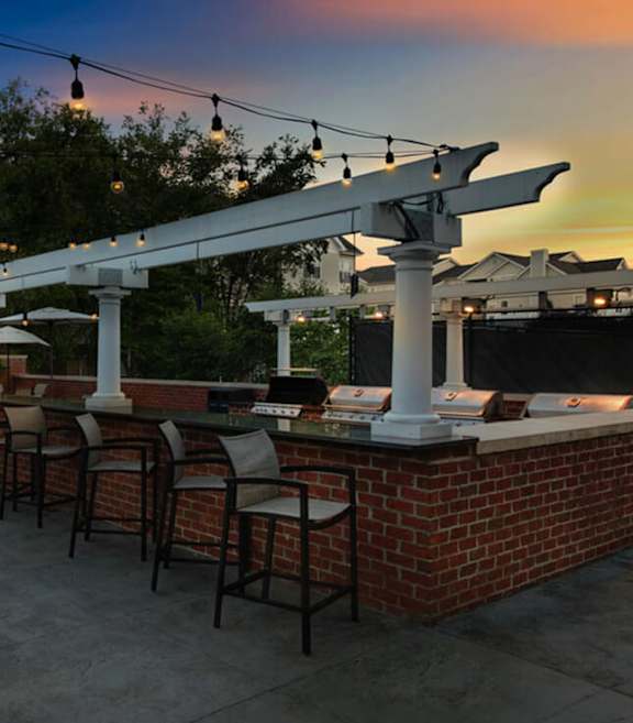 Outdoor BBQ Area with Canopy and Lights at Dulles Green Apartments located in Herndon, VA-SMLAM.