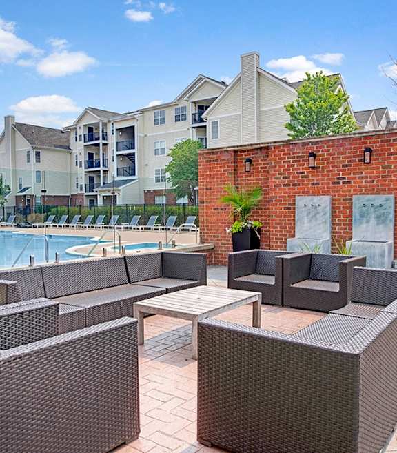 Community Swimming Pool with Pool Furniture at Dulles Green Apartments located in Herndon, VA-SMLAM.