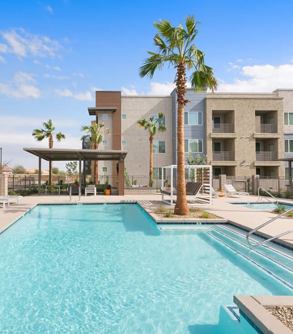 Community Swimming Pool with Pool Furniture at Parc Roundtree Ranch Apartments located in Peoria, AZ-SMLAM.