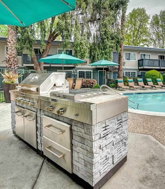 Outdoor Grilling Stations and View of Pool at Los Gatos Landing Apartments located in San Jose, CA-SMLAM.