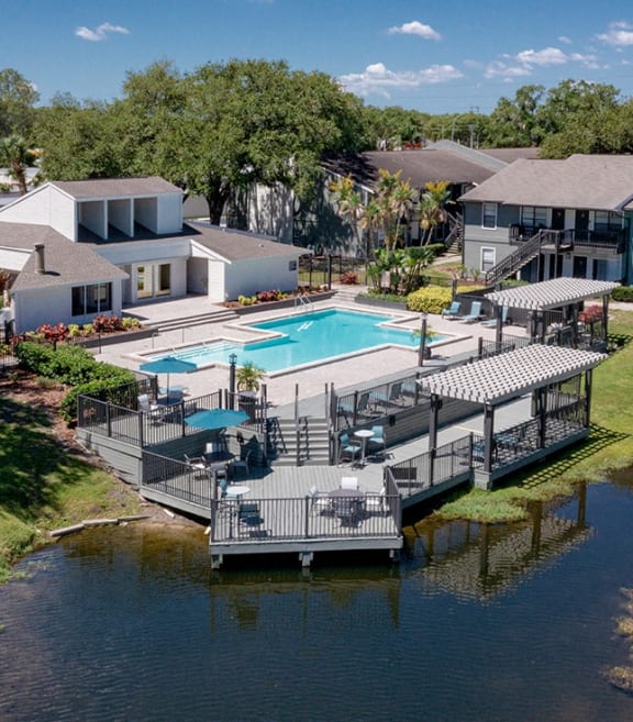 Lakeside swimming pool at Seven Lakes at Carrollwood Apartments in Tampa, FL