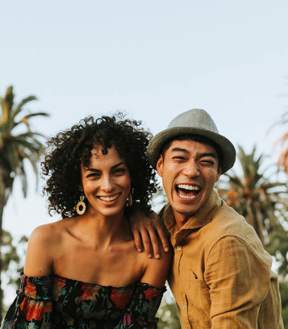 Stock Photo of Friends Smiling by Palm Trees-SMLAM.