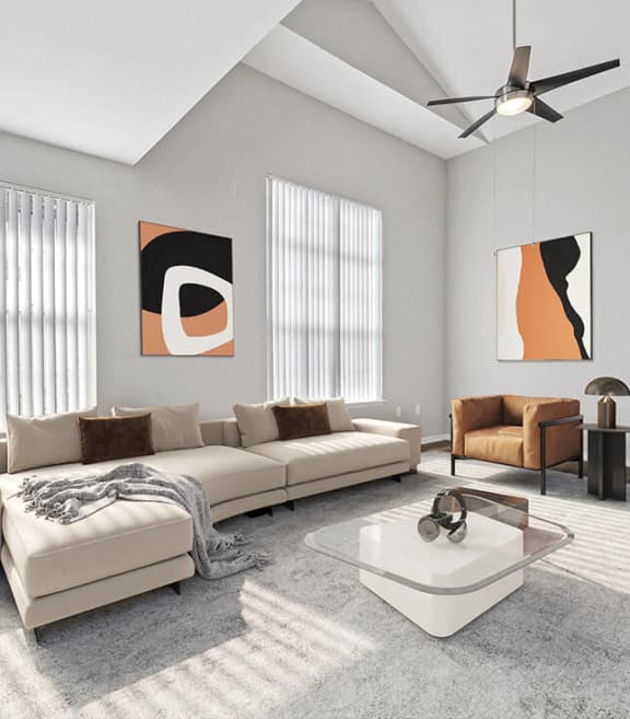 Model living room with large windows at Veranda at Westchase Apartments in Tampa, Florida