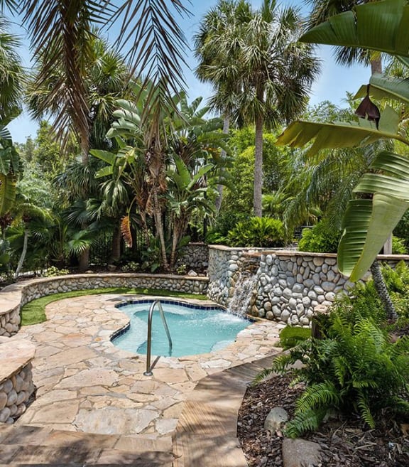 Spa surrounded by tropical greenery at Veranda at Westchase Apartments in Tampa, Florida