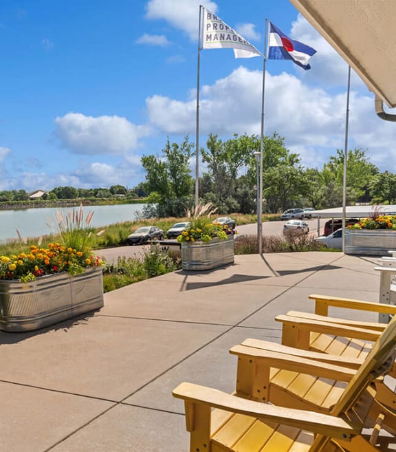 Patio facing lake with chairs at Waterfront Apartments in Lakewood, Colorado