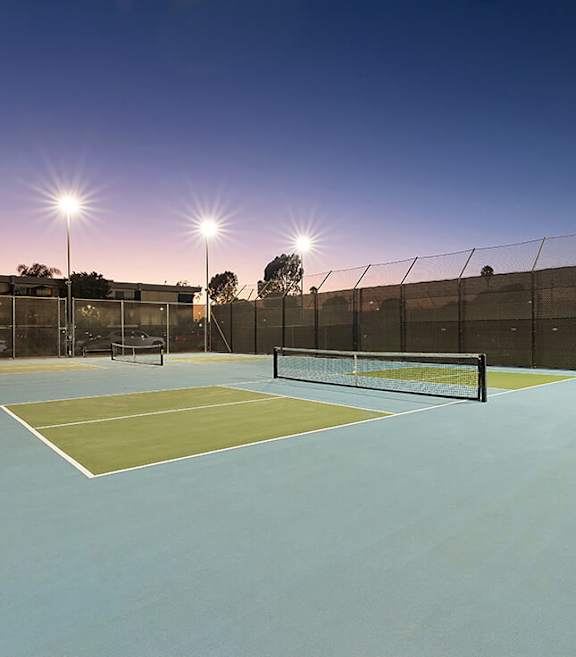 Community Tennis Court with Nets at Madison Park Apartments located in Anaheim