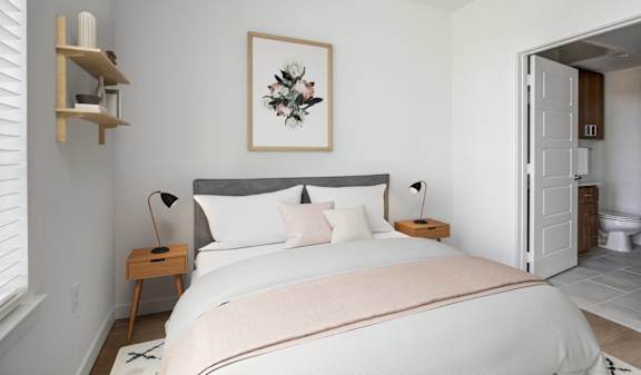 a bedroom with a bed and a bathroom with a toilet