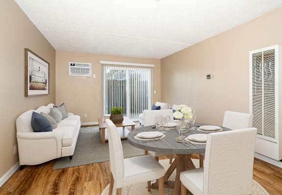 a living room and dining room with a table and chairs