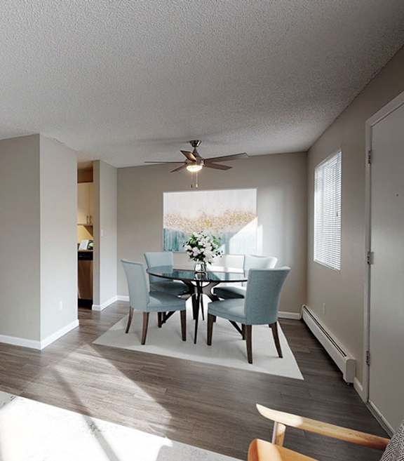 A dining room with a table and chairs.