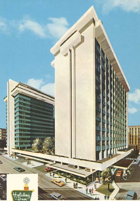 A Holiday Inn sign is displayed in front of a large building.