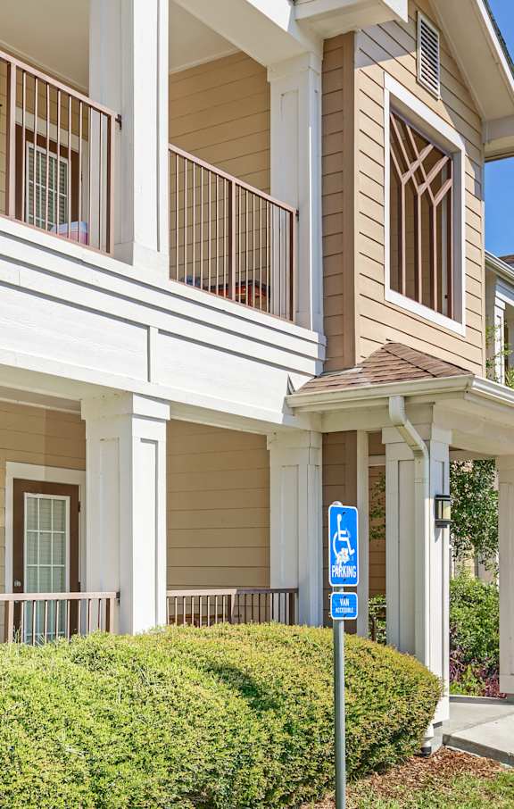 A blue and white sign is in front of a building.