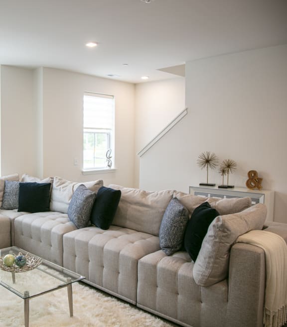 a living room with a couch and a coffee table at Enclave Crystal Lake Townhomes and Apartments, Crystal Lake, Illinois