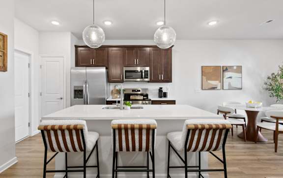 a view of a kitchen with a island and blue chairs