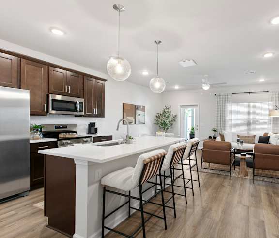 A modern kitchen with a dining area and a living room.