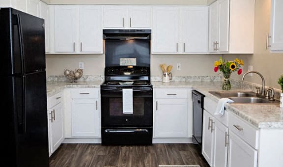 Kitchen with black applicances at Crosstimbers Apartments