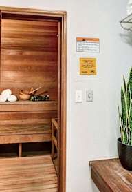 A bathroom with a wooden door and a towel rack.