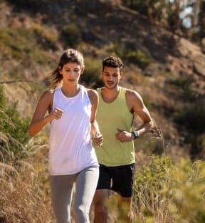 Two people jogging on a trail