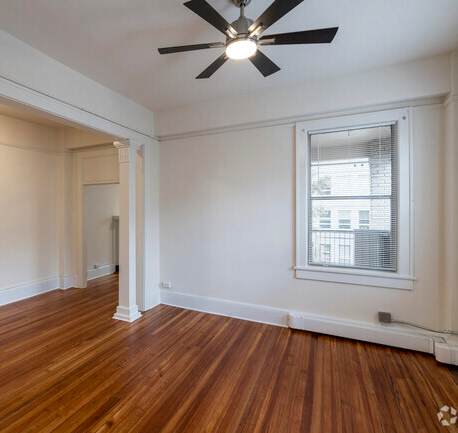 the living room and dining room of an empty house with wood floors and a ceiling