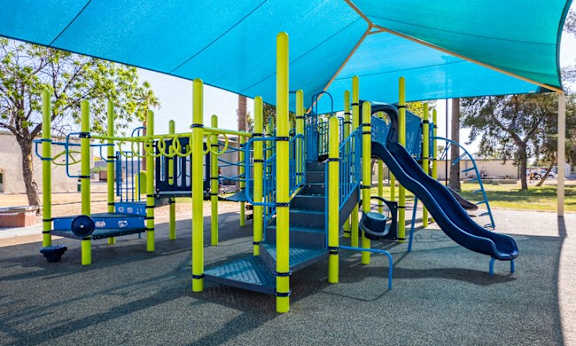 a playground with a blue canopy over it