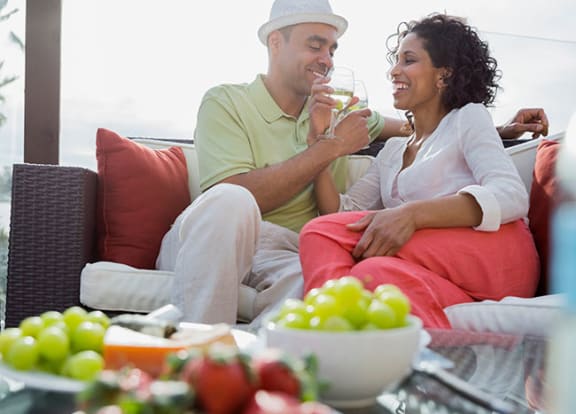 Couple sitting outside with food  at Bay Winds, Florida