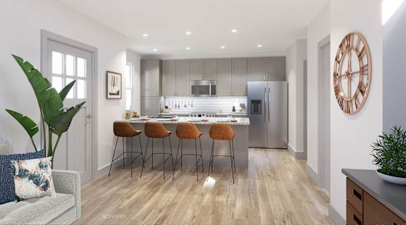 A modern kitchen with a dining table and chairs.