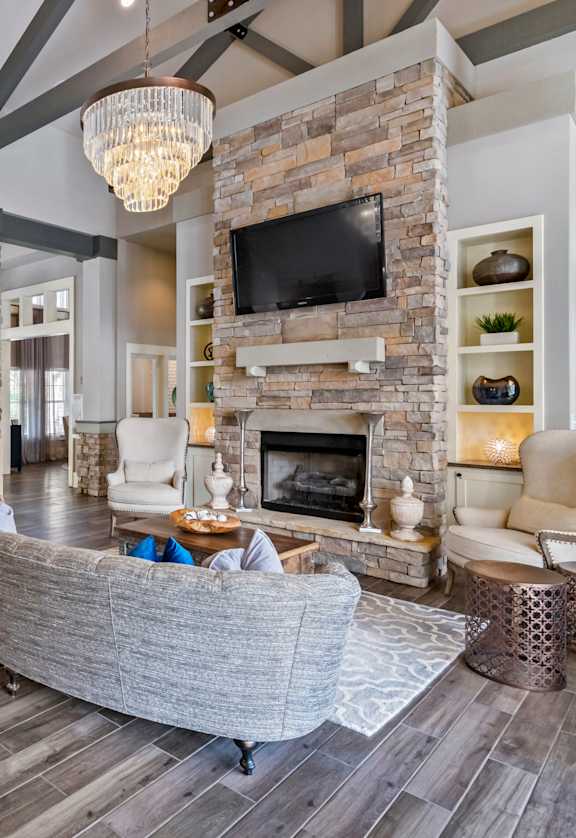 a living room with a large stone fireplace and a couch