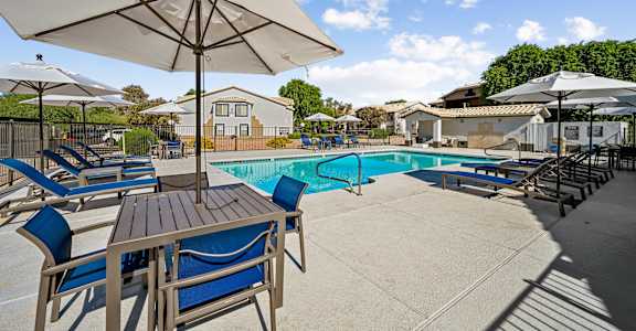 our apartments have a resort style pool with tables and chairs