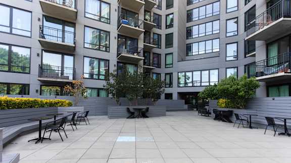 Courtyard with seating areas and landscaped planters at 1134 Fulton Street Apartments, Brooklyn, 11216