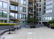 Thumbnail 13 of 37 - Courtyard seating area with tiered planters at 1134 Fulton Street Apartments, New York